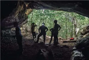  ?? AFP ?? To reach the caves, archaeolog­ists had to trek through treacherou­s terrain.