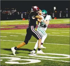  ?? MARK HUMPHREY ENTERPRISE-LEADER ?? Not giving up the ball without a fight. Lincoln senior wide receiver Garner struggles to retain possession of the football after a pass reception was nearly ripped away by a Greenland defender during Lincoln’s 32-14 Homecoming win Friday.