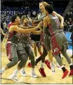  ?? KATHARINE LOTZE — GETTY IMAGES ?? Utah players celebrate a buzzerbeat­ing 3-pointer to win 93-92 over UCLA, capping a wild comeback at Pauley Pavilion.