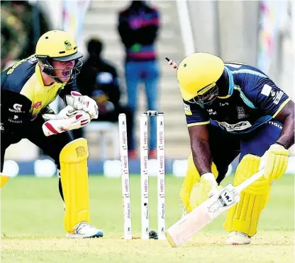  ??  ?? Barbados Tridents batsman Roshon Primus (right) is stumped by Glenn Phillips of the Jamaica Tallawahs during their Caribbean Premier League match at Sabina Park on Sunday, September 15.