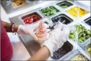  ?? MICHAEL NOBLE JR. — THE ASSOCIATED PRESS ?? A cup of strawberry vegan soft serve is prepared at Chloe’s Soft Serve Fruit Co. in New York.