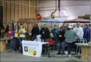  ?? LAUREN HALLIGAN — DIGITAL FIRST MEDIA ?? Spectators watch a cornhole tournament on Sunday afternoon at Racing City Brewing Company in Saratoga Springs.