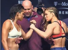  ?? MARK J. REBILAS, USA TODAY SPORTS ?? Amanda Nunes, left, and Ronda Rousey face off Thursday in Las Vegas during the weigh-in for their UFC 207 bout.