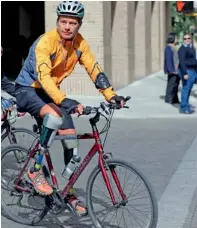  ??  ?? Carlos Gutierrez, a double amputee, rides his bike in San Antonio. — AP