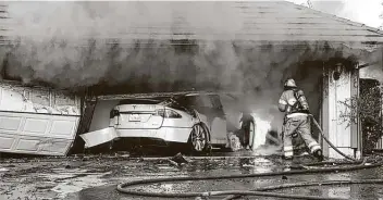  ?? Orange County Sheriff’s Department / Associated Press ?? The Orange County Fire Authority battles a fire on a burning vehicle in Orange County, Calif. Firefighte­rs identified the fuel source of the blaze as the SUV’S high-voltage battery pack.