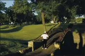  ??  ?? Harold Varner III examines his ball that landed on a bridge after his tee shot on the 10th hole during the second round of the Charles Schwab Challenge golf tournament at the Colonial Country Club in Fort Worth, Texas.