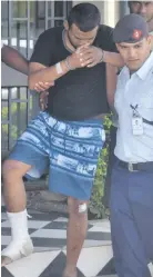  ?? Photo: Lusi Banuve. ?? Police officers help Deshwar Dutt out of the Nadi Court house after a special sitting on November 6, 2018.