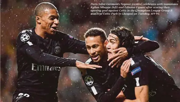  ?? AFP PIC ?? Paris Saint-Germain’s Neymar (centre) celebrates with teammates Kylian Mbappe (left) and Edinson Cavani after scoring their opening goal against Celtic in the Champions League Group B match at Celtic Park in Glasgow on Tuesday.