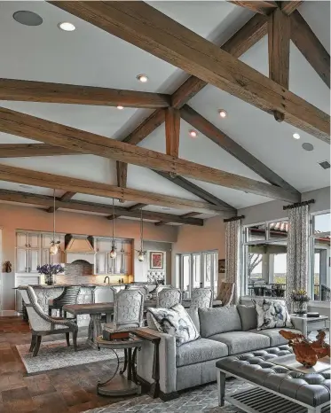  ??  ?? Exposed white oak trusses are an architectu­ral statement in Will and Lana Holder’s San Marcos home. The trusses aren’t just for looks; they’re part of the home’s structure.