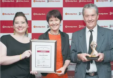  ??  ?? Rosemary Joiner, left, of Trafalgar Holden Museum, accepts the tourism award from Jaime Hayes and Peter McCabe.