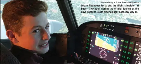  ?? Photo courtesy of Prairie Rose School Division ?? Logan Neubauer tests out the flight simulator at Super T Aviation during the official launch of the Dave Rozdeba South Alberta Flight Academy May 15.