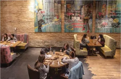  ?? RICH HEIN/SUN-TIMES FILES ?? Patrons enjoy indoor dining at Nando’s Peri-Peri Chicken in Naperville in October.