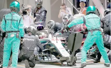  ??  ?? Mercedes’ Lewis Hamilton returns to the pit during the Singapore Grand Prix night race, in Singapore. — Reuters photo