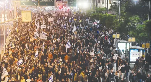  ?? (Tomer Neuberg/Flash90) ?? PROTESTERS AGAINST the proposed changes to the legal system demonstrat­e in Tel Aviv last night.