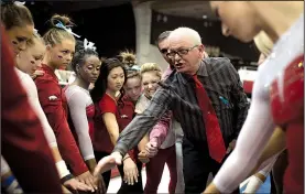  ?? NWA Democrat-Gazette/CHARLIE KAIJO ?? Coach Mark Cook (center) and Arkansas’ gymnastics team will compete at the NCAA championsh­ips for the first time in four years today at Chaifetz Arena in St. Louis. A record six teams from the SEC qualified for the NCAA championsh­ips.