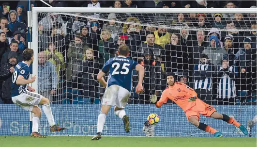  ?? — AFP ?? West Bromwich Albion’s Jay Rodriguez (left) scores against Arsenal in their English Premier League match at the Hawthorns Stadium in West Bromwich on Sunday. The match ended in a 1-1 draw.