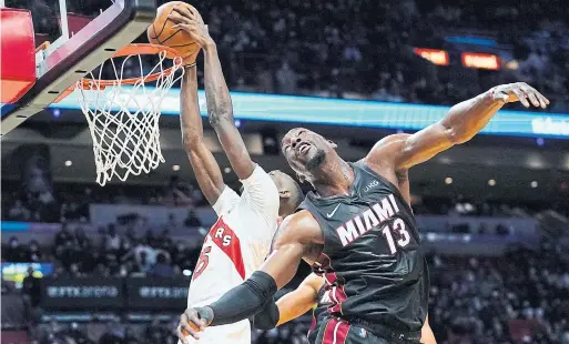  ?? LYNNE SLADKY THE ASSOCIATED PRESS ?? Raptors forward Chris Boucher dunks over Miami Heat centre Bam Adebayo for two of his 21 points.