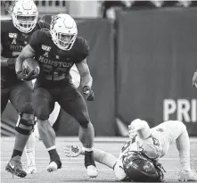  ?? Karen Warren / Staff photograph­er ?? UH’s opening odyssey includes Kyle Porter, left, running into Washington State on a Friday night at NRG Stadium.