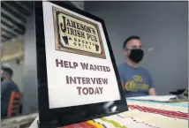  ?? MARCIO JOSE SANCHEZ — THE ASSOCIATED PRESS ?? A hiring sign sits at a booth for Jameson’s Irish Pub during a job fair in West Hollywood, a Los Angeles County city. Hiring gains lowered California’s unemployme­nt rate to 7.3%, tied with Nevada for the highest in the nation. New data released Friday by the Employment Developmen­t Department shows California has averaged more than 100,000new jobs each month since February.