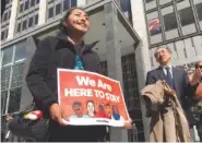  ?? THE ASSOCIATED PRESS ?? Erica Leyva with the Services, Immigrant Rights and Education Network of San Jose, Calif., carries a sign Friday outside a San Francisco courthouse.