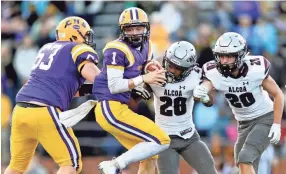  ??  ?? Covington's Brock Lomax (1) tries to evade Alcoa's J.R. Jones (28) and Tyler Boyd (20) during a game between Alcoa and Covington at the TSSAA Blue Cross Bowl at Tennessee Tech's Tucker Stadium in Cookeville, Tennessee on Saturday, December 1, 2018. CALVIN MATTHEIS/NEWS SENTINEL