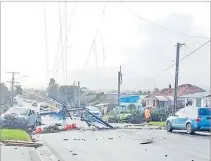  ?? Picture: Ben Wilson/RNZ ?? Downed power lines and damaged roofs after Saturday’s tornado in New Zealand.