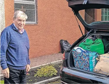  ?? ?? Overwhelmi­ng response
Club president Martin Cairney with donations from St Andrew’s Church in Airdrie