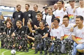  ??  ?? Members of France’s Bordeaux University (left in black) celebrate their victory in the kid-size android football tournament final against China at the RoboCup 2017 in Nagoya, Aichi prefecture yesterday. — AFP photos