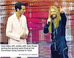  ?? AP PHOTO/LUCA BRUNO ?? Host Mika, left, smiles with Sam Ryder during the second semi-final at the Eurovision Song Contest in Turin