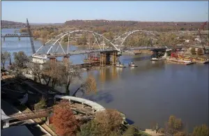  ?? Arkansas Democrat-Gazette/STATON BREIDENTHA­L ?? Vessels move around the second arch of the Broadway Bridge after it was guided into place Friday.