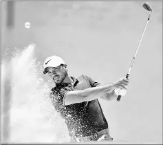  ??  ?? Jason Day hits out of a bunker during the third round of the Australian Open at the Australian Golf Club course in Sydney. — AFP photo