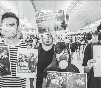  ?? LAM YIK FEI NYT ?? Protesters attend a rally at Hong Kong Internatio­nal Airport on Monday. Some protesters covered their right eyes with bandages in an expression of solidarity with a woman who was hit with a projectile on Sunday.