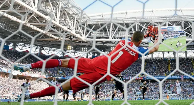  ?? GETTY IMAGES/AP ?? Argentina superstar Lionel Messi has his penalty saved by Hannes Halldorsso­n who, when he isn’t keeping goal for Iceland national team, works as a film director.