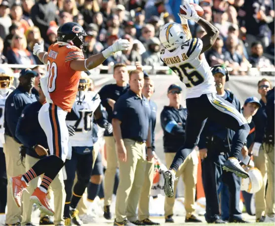  ?? PAUL BEATY/AP ?? Chargers cornerback Casey Hayward intercepts a pass from Mitch Trubisky intended for Bears tight end Trey Burton in the third quarter Sunday at Soldier Field.