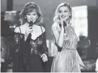  ?? THE ASSOCIATED PRESS ?? Reba McEntire, left, and Kelsea Ballerini perform “Legends” at the 51st annual CMA Awards at the Bridgeston­e Arena on Wednesday in Nashville.