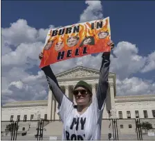  ?? AP ?? ANGRY VOICES: An abortion-rights protester displays a placard during a demonstrat­ion Saturday outside the Supreme Court in Washington.
