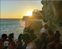  ?? ALBERT STUMM VIA AP ?? This photo shows the Cova d’en Xoroi bar on the southern cliff of the island of Menorca, Spain. After dark the cave turns into a nightclub with live music or DJs.