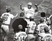  ?? BLAIR PITTMAN / HOUSTON CHRONICLE ?? Jimmy Wynn of the Houston Astros is greeted at the plate after a home run in Houston in 1972. Wynn was born in Cincinnati and attended Central State University.