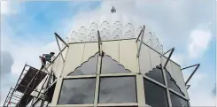  ??  ?? Harpreet Singh Gill inspects the massive dome that tops the roof. The large dome towers 36 metres above the ground and weighs around 3,000 kilograms. The domes were built in India.