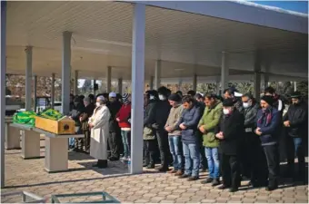  ?? AP PHOTO/FRANCISCO SECO ?? Men pray Sunday during the funeral of two people killed during the earthquake at Sehir cemetery in Malatya, Turkey.