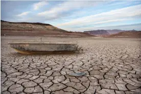  ?? Photograph: Mario Tama/Getty Images ?? A formerly sunken boat rests on a now-dry section of lakebed at the drought-stricken Lake Mead, Nevada.