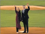  ?? PATRICK T. FALLON — AFP VIA GETTY IMAGES ?? California Gov. Gavin Newsom and his wife, Jennifer Siebel Newsom, wave Tuesday at Dodger Stadium in Los Angeles.