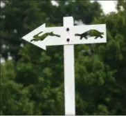  ??  ?? In this July 7 photo, the tortoise and hare sign on the cross country course is shown at Van Cortlandt Park in the Bronx.