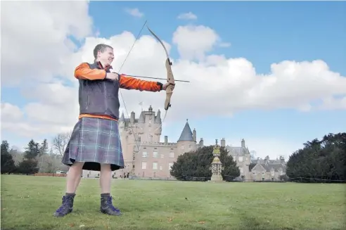 ?? PHOTOS: STEVE MACNAULL/POSTMEDIA NEWS ?? Ross Boardman of Boots N Paddles teaches archery on the front lawn of Glamis Castle (the childhood home of the late Queen Mother) as part of Adventures by Disney’s A Brave Adventure tour of Scotland.