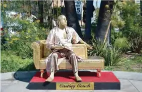  ??  ?? A gold sculpture of Harvey Weinstein on his infamous casting couch holding an Oscar statue is on display in Hollywood, California. — AFP