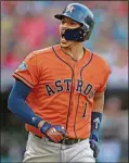  ?? [DAVID DERMER/THE ASSOCIATED PRESS] ?? Houston Astros’ Carlos Correa looks at the dugout as he runs the bases after hitting a three-run home run in the eighth inning during Game 3 of a baseball American League Division Series against the Cleveland Indians on Monday in Cleveland. Marwin Gonzalez and Yuli Gurriel scored on the play.