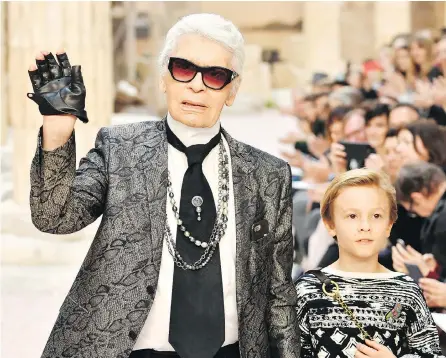  ?? PASCAL LE SEGRETAIN / GETTY IMAGES FILES ?? Designer Karl Lagerfeld and nephew Hudson Kroenig walk the runway during Chanel Cruise 2017/2018 Collection at Grand Palais on May 3, 2017 in Paris. Lagerfeld died early Tuesday in Paris.