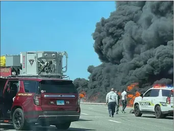  ?? COURTESY / ANGELIQUE FELICIANO, VIA AP ?? This photo shows firefighte­rs and police responding after a crash involving a fuel truck and a car sparked a fire on the Gold Star Bridge between New London and Groton, Conn., on Friday, April 21, 2023.