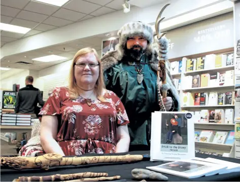  ?? LAURA BARTON/WELLAND TRIBUNE ?? Victoria Young Bennison sits at a table set up outside of Coles in Seaway Mall in Welland \ Saturday where she was signing copies of her new book, Stick to the Story. The book features folklore and creative stories about the sticks her husband Dave...