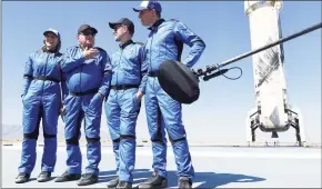  ?? Mario Tama / Getty Images ?? Star Trek actor William Shatner, 90, second from left, with fellow crew members on the landing pad of Blue Origin’s New Shepard spacecraft after flying into space Wednesday, near Van Horn, Texas.